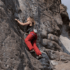 mujer escalando roca en valle chilina